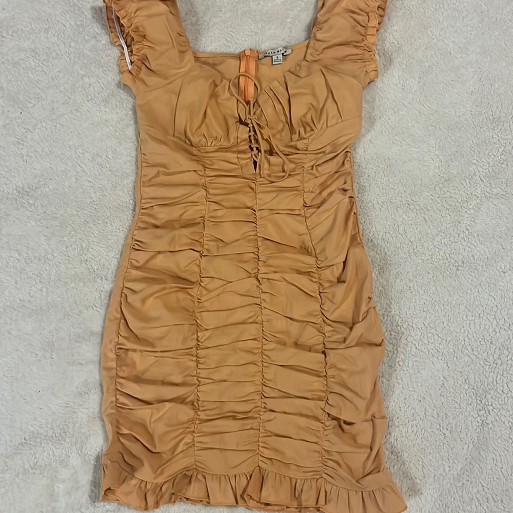 This dress is fitting and is very sexy. Also ties in the front.